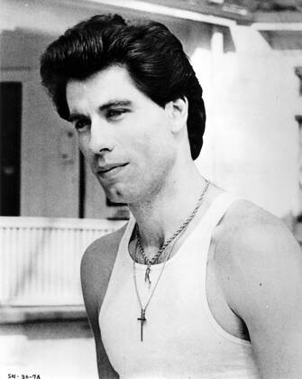 SATURDAY NIGHT FEVER JOHN TRAVOLTA Date: 1977. Strictly editorial use only in conjunction with the promotion of the film. Credit line mandatory. This image is copyright of the film company and is supplied under the terms of issue as film still. No commercial or book cover use permitted without prior consent from the film company.  Mandatory credit line: Image courtesy Robert Stigwood Organization Paramount Pictures Ronald Gra