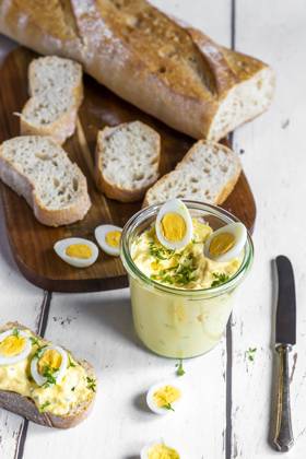 Sliced baguette and jar of homemade egg salad with cress SARF04610