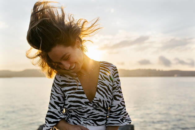 Beautiful woman tossing hair against clear sky model released Symbolfoto MGOF04389