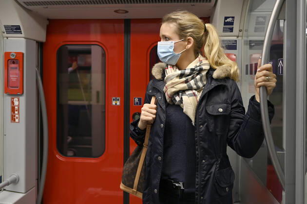 Woman with face mask, standing in S Bahn, Corona crisis, Stuttgart, Baden Württemberg, Germany Coronavirus