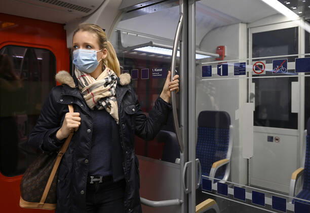 Woman with face mask, standing in S Bahn, Corona crisis, Stuttgart, Baden Württemberg, Germany Coronavirus