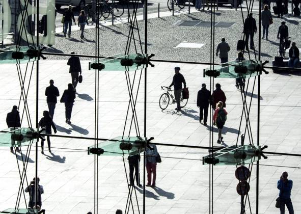 People at the station Silhouettes of people can be seen behind a glass wall at Berlin Central Station on 26 09 2016 Berlin Berlin Germany