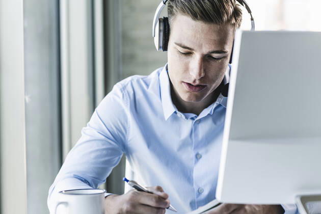 Close-up of male customer representative wearing headset while working in call center model released Symbolfoto property released UUF21479