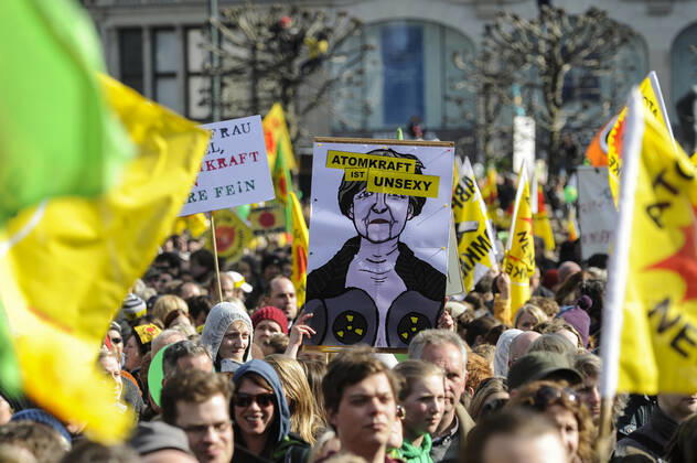 DEUTSCHLAND, Hamburg, DEMO fuer Atomausstieg nach Havarie im AKW Fukushima in Japan, Plakat mit Bild der Bundeskanzlerin Angela Merkel mit Schriftzug Atomkraft ist unsexy Hamburg Germany