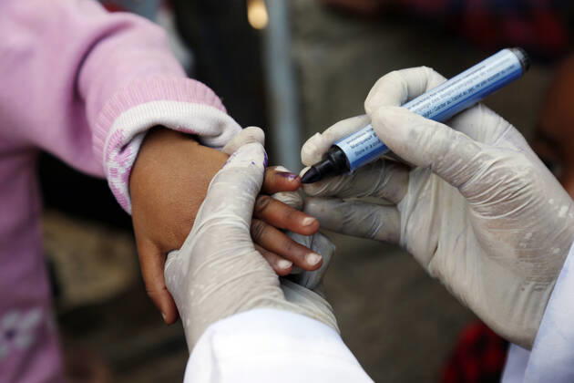 (201128) -- SANAA, Nov. 28, 2020 -- A medical worker marks a child s finger after giving her a dose of polio vaccine in Sanaa, Yemen, on Nov. 28, 2020. Yemen s health authorities on Saturday launched a polio vaccination campaign for more than 4 million children in the north of the war-torn country. The three-day campaign is supported by the World Health Organization, the UNICEF and other international aid agencies, the local health authorities said in a statement. (Photo by Xinhua) YEMEN-SANAA-CHILDREN-POLIO VACCINATION MohammedxMohammed 