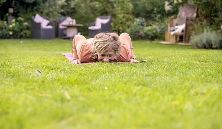 Woman doing push-ups in the garden