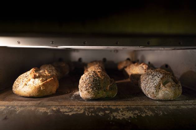 Loaves of delicious bread with crispy crust in hot oven, Model released Copyright: xDavidxAguerox MR