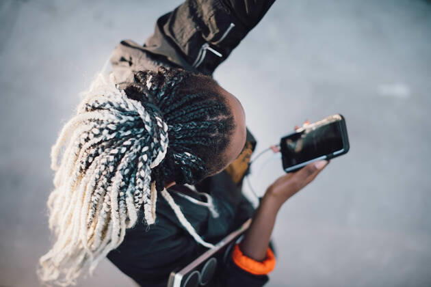 IMAGO Creative: Sport Start-Up High angle view of teenage girl with dreadlocks dancing while holding smart phone at skateboard park , model released Copyright: xMaskotx , MA68503