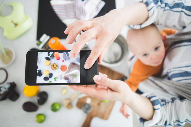 High angle view of female influencer food blogging with baby girl in kitchen , model released, property released Copyright: xMaskotx , MA71895