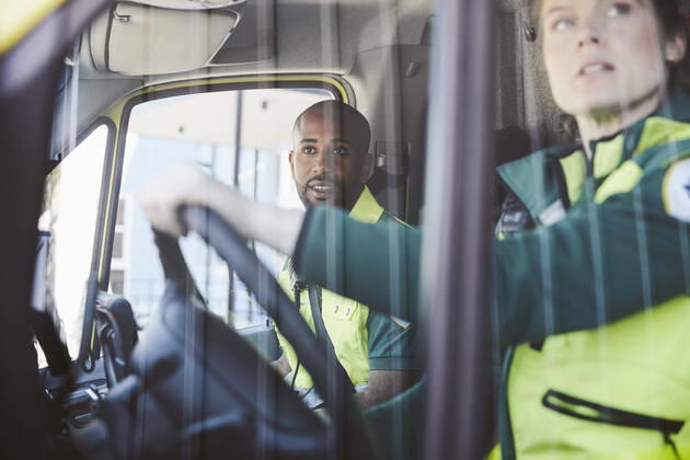 Male and female paramedics looking from ambulance window , model released Copyright: xMaskotx , MA72673