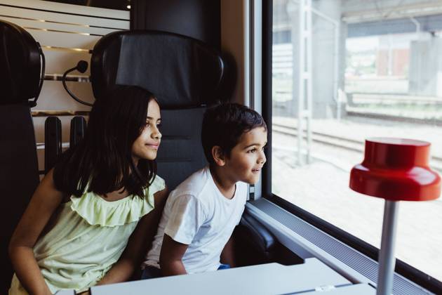 Siblings looking through train window while traveling together , model released, property released Copyright: xMaskotx , MA74763