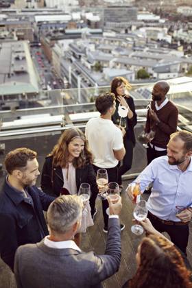 High angle view of coworkers toasting wineglasses while partying at building terrace , model released, property released Copyright: xMaskotx , MA74830