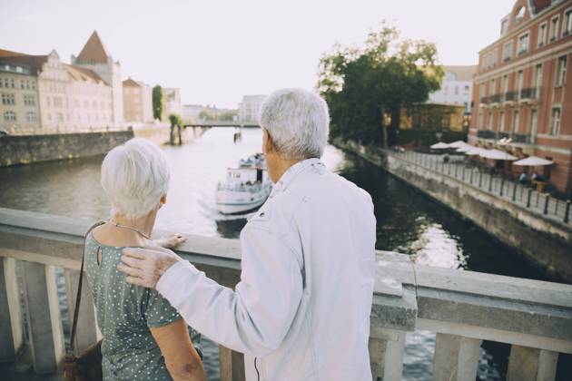 IMAGO Creative, Jahreszeit Sommer, Sommer in der Stadt Rear view of senior couple standing on bridge against railing in city , model released Copyright: xMaskotx , MA77996
