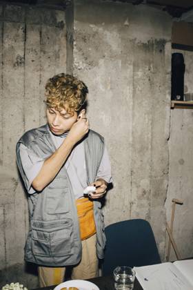 Businessman wearing in-ear headphones against wall in workplace Sweden, Stockholm, model released, property released Copyright: xMaskotx , MA79579