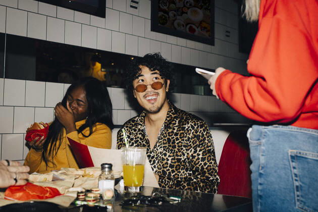 Midsection of waitress taking order from cheerful male and female friends in cafe Sweden, Stockholm, model released, property released Copyright: xMaskotx , MA79649
