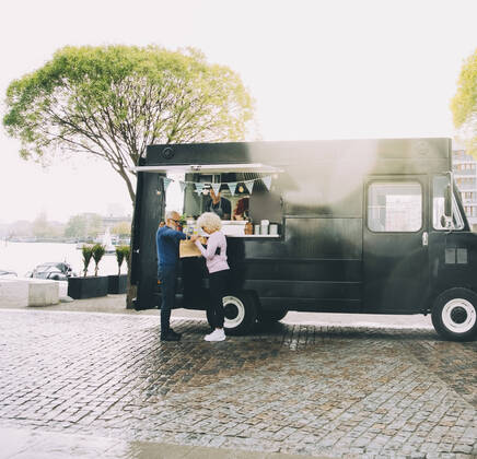 Owner talking to senior customers while standing in commercial land vehicle Sweden, Stockholm, model released, property released Copyright: xMaskotx , MA81605