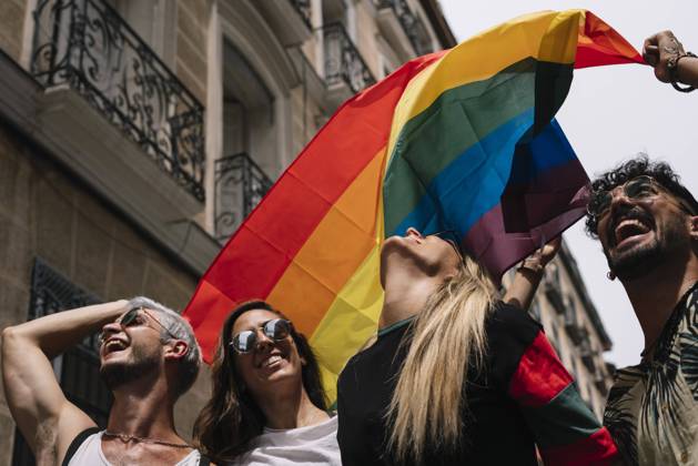Group of friends with a flag of gay pride in the city of Madrid Copyright: xJosexLuisxCarrascosax Model Released