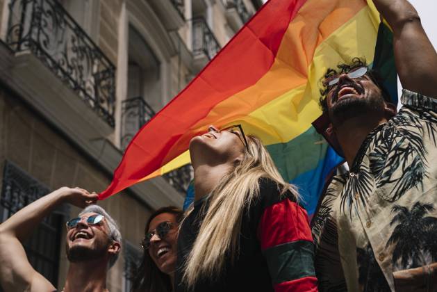 Group of friends with a flag of gay pride in the city of Madrid Copyright: xJosexLuisxCarrascosax Model Released