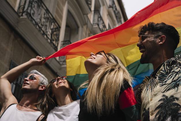 Group of friends with a flag of gay pride in the city of Madrid Copyright: xJosexLuisxCarrascosax Model Released