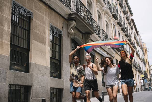 Group of friends with a flag of gay pride in the city of Madrid Copyright: xJosexLuisxCarrascosax Model Released