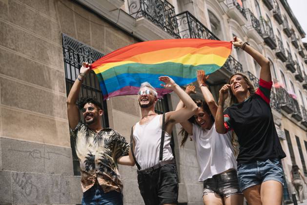 Group of friends with a flag of gay pride in the city of Madrid Copyright: xJosexLuisxCarrascosax Model Released
