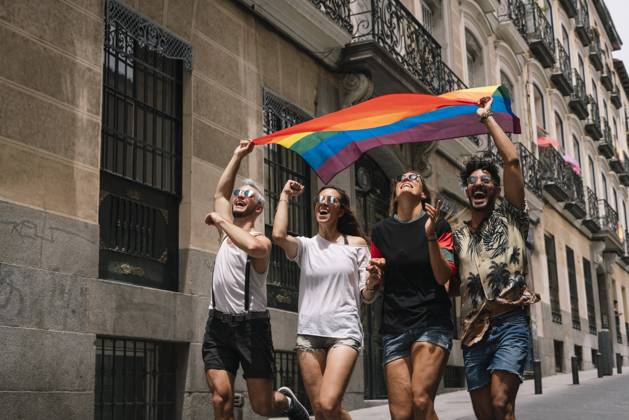 Group of friends with a flag of gay pride in the city of Madrid Copyright: xJosexLuisxCarrascosax Model Released