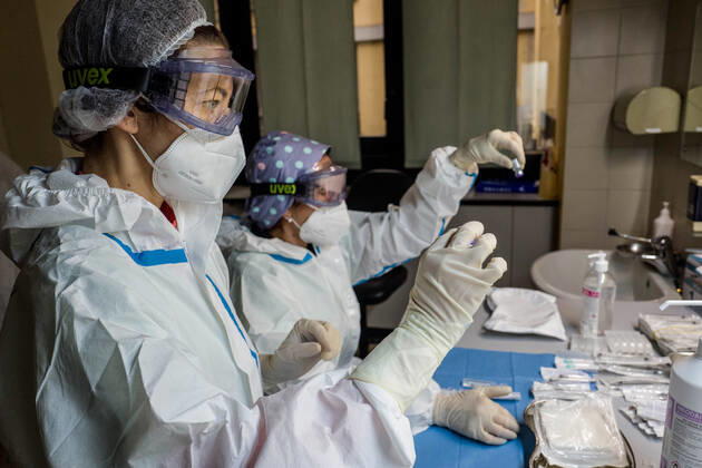 Milan. COVID19 Vaccine Mixing and preparation of the assay before administration Editorial Usage Only  Copyright: xCarloxCozzolix xIPAx