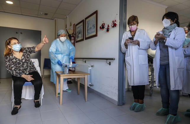 The director of the residence, Josefa Martinez is vaccinated after the Batiste Marti of 81 years, during the first day of vaccination against Covid-19 in Spain, in the residence for elderly Virgen del Milagro de Rafelbunyol, in Valencia (Spain), on December 27, 2020. The first doses of the vaccine developed by Pfizer and BioNtech laboratories arrived in Spain yesterday, December 26, at a Pfizer warehouse in Guadalajara by land from Puurs (Belgium). Starting Monday, weekly deliveries will be made to the autonomous communities with an average of 350,000 doses prioritized for four population groups: residents and health and social-health personnel in homes for the elderly and disabled; front-line health personnel; other health and social-healt Copyright: xRoberxSolsonax 3494960