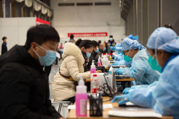 (210102) -- BEIJING, Jan. 2, 2021 -- People fill the informed consent form out before the COVID-19 vaccination at a temporary vaccination site in Beijing, capital of China, Jan. 2, 2021. Beijing started administering COVID-19 vaccines among specific groups of people with higher infection risks. Nine groups of people aged 18 to 59 will receive the vaccine before the Spring Festival of 2021, which falls on Feb. 12. These include frontline customs inspectors of imported cold-chain goods and personnel working in the overseas and domestic transportation sector. ) CHINA-BEIJING-COVID-19-VACCINATION (CN) ChenxZhonghao 