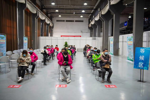 (210102) -- BEIJING, Jan. 2, 2021 -- People wait for receiving COVID-19 vaccines at a temporary vaccination site in Beijing, capital of China, Jan. 2, 2021. Beijing started administering COVID-19 vaccines among specific groups of people with higher infection risks. Nine groups of people aged 18 to 59 will receive the vaccine before the Spring Festival of 2021, which falls on Feb. 12. These include frontline customs inspectors of imported cold-chain goods and personnel working in the overseas and domestic transportation sector. ) CHINA-BEIJING-COVID-19-VACCINATION (CN) ChenxZhonghao 