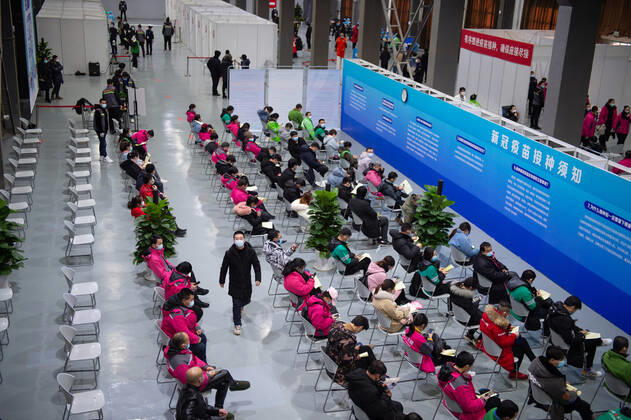 (210102) -- BEIJING, Jan. 2, 2021 -- People sit for 30 minutes of observation after receiving COVID-19 vaccines at a temporary vaccination site in Beijing, capital of China, Jan. 2, 2021. Beijing started administering COVID-19 vaccines among specific groups of people with higher infection risks. Nine groups of people aged 18 to 59 will receive the vaccine before the Spring Festival of 2021, which falls on Feb. 12. These include frontline customs inspectors of imported cold-chain goods and personnel working in the overseas and domestic transportation sector. ) CHINA-BEIJING-COVID-19-VACCINATION (CN) ChenxZhonghao 