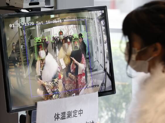 Coming-of-age ceremony under virus state of emergency A woman has her temperature checked before entering the venue of a coming-of-age ceremony in Tokyo s Suginami Ward on Jan. 11, 2021, as the capital is under a coronavirus state of emergency.