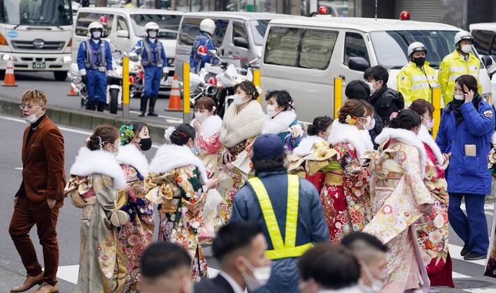 Coming-of-age ceremony under virus state of emergency Women in kimono walk near the venues of a coming-of-age ceremony in Yokohama near Tokyo on Jan. 11, 2021. The ceremony was split into two venues to avoid concentration of people as the Tokyo metropolitan area is under a coronavirus state of emergency amid the continued pandemic.