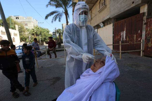 January 11, 2021, Deir Al-Balah, Gaza Strip, Palestinian Territory: A Palestinian medical worker wearing protective gear, takes a random swab sample for COVID-19 testing, in Deir al-Balah, central of Gaza Strip, on January 11, 2021. The Palestinian Authority (PA) has said it expects to receive its first COVID-19 vaccine doses in March under a deal with British drug giant AstraZeneca, and accused Israel of ignoring its responsibilities to ensure vaccines are available in occupied territory Deir Al-Balah Palestinian Territory - ZUMAap3_ 20210111_zaf_ap3_032 Copyright: xAshrafxAmrax