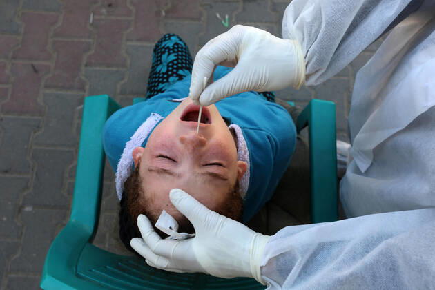 January 11, 2021, Deir Al-Balah, Gaza Strip, Palestinian Territory: A Palestinian medical worker wearing protective gear, takes a random swab sample for COVID-19 testing, in Deir al-Balah, central of Gaza Strip, on January 11, 2021. The Palestinian Authority (PA) has said it expects to receive its first COVID-19 vaccine doses in March under a deal with British drug giant AstraZeneca, and accused Israel of ignoring its responsibilities to ensure vaccines are available in occupied territory Deir Al-Balah Palestinian Territory - ZUMAap3_ 20210111_zaf_ap3_042 Copyright: xAshrafxAmrax