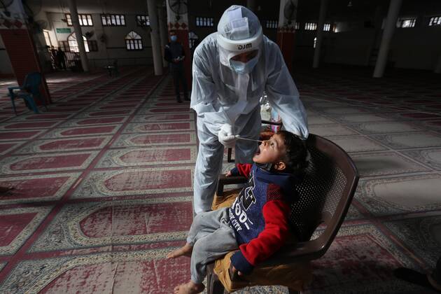 January 11, 2021, Deir Al-Balah, Gaza Strip, Palestinian Territory: A Palestinian medical worker wearing protective gear, takes a random swab sample for COVID-19 testing inside a mosque, in Deir al-Balah, central of Gaza Strip, on January 11, 2021. The Palestinian Authority (PA) has said it expects to receive its first COVID-19 vaccine doses in March under a deal with British drug giant AstraZeneca, and accused Israel of ignoring its responsibilities to ensure vaccines are available in occupied territory Deir Al-Balah Palestinian Territory - ZUMAap3_ 20210111_zaf_ap3_068 Copyright: xAshrafxAmrax