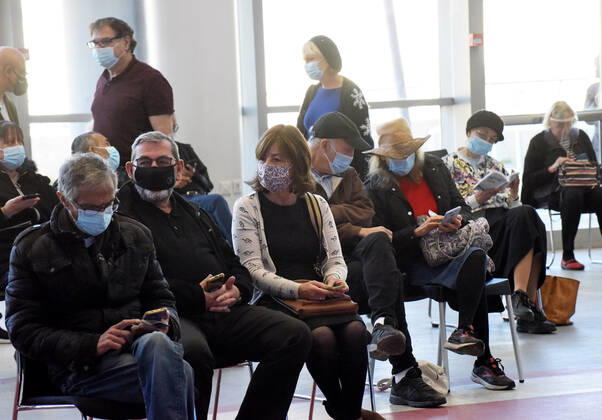 People wait to receive their second shot of the Pfizer- BioNTech COVID-19 vaccine in an Israeli vaccination center in Jerusalem, on Tuesday, January 12, 2021. Israel will expand the vaccination drive inoculating teachers and people over 50 years on Wednesday.  JER2021011202 DEBBIExHILL
