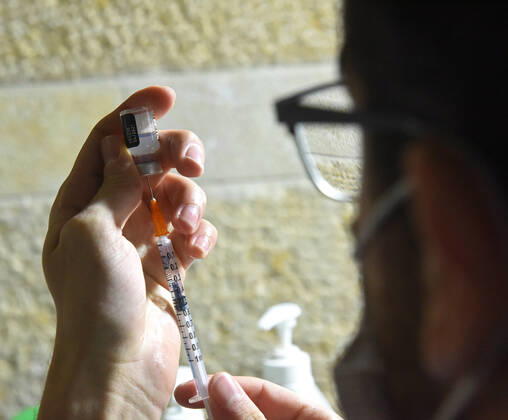 A nurse prepares a syringe with the Pfizer- BioNTech COVID-19 vaccine in an Israeli vaccination center in Jerusalem, on Tuesday, January 12, 2021. Israel will expand the vaccination drive inoculating teachers and people over 50 years on Wednesday.  JER2021011206 DEBBIExHILL