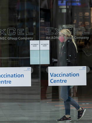 (210113) -- LONDON, Jan. 13, 2021 -- A woman wearing a face mask is seen in the Vaccination Centre at ExCel exhibition centre in London, Britain, Jan. 12, 2021. British Prime Minister Boris Johnson on Monday warned against false complacency as the country is seeking to speed up the coronavirus vaccine rollout. According to the prime minister, 2.4 million coronavirus jabs have been administered across Britain. Seven new mass vaccination sites in England opened Monday, as the country races against time to bring the pandemic under control. ) BRITAIN-LONDON-COVID-19-VACCINE ROLLOUT HanxYan 
