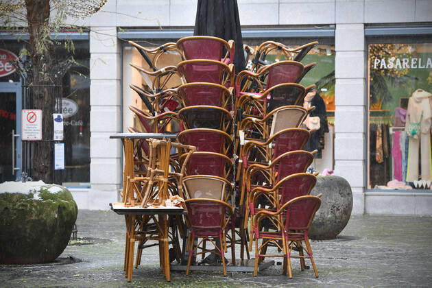 Theme picture Coronavirus pandemic consequences for the gastronomy stacked chairs and tables in the outdoor area of a restaurant in Munich on 12 01 2021