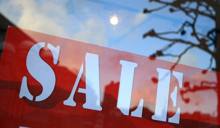 On the window of a closed shop in the city centre of Hamburg a sale is advertised Altstadt Hamburg