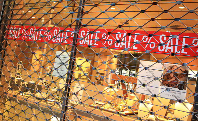 On the window of a closed shop in the city centre of Hamburg a sale is advertised Altstadt Hamburg