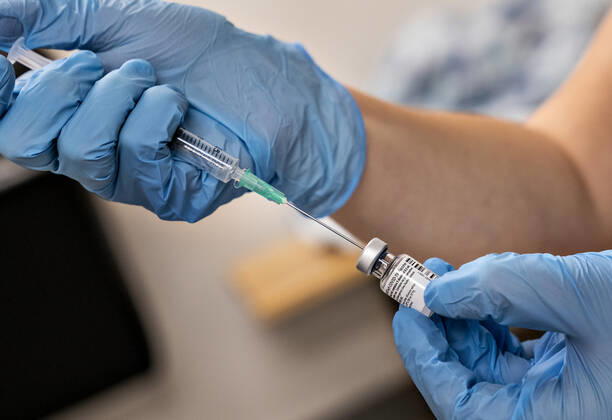 A doctor is preparing a covid 19 vaccine for vaccination of 65 citizens, who receive both personal care and practical assistance from the municipality, in Brovst Hallen, Wednesday 13 January 2021 In other words, one of the 22 nearby vaccination sites that have been set up for this is inaugurated here. target group of citizens, Brovst Jylland Denmark  Copyright: HenningxBagger HenningxBaggerx COP102 spdk20210113-131615-L