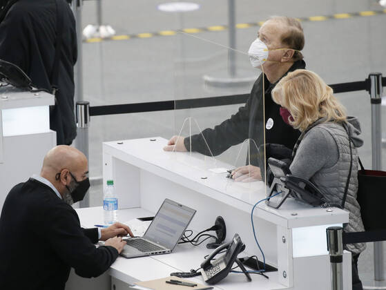 Patients arrive and go through the check in process to received a COVID-19 vaccination at the Jacob K. Javits Convention Center in New York City on Wednesday, January 13, 2021. The Javits Convention Center which served as a massive field hospital last spring when New York City was the epicenter of the pandemic, now will serve as a huge vaccine distribution center.  NYP20210113107 JohnxAngelillo