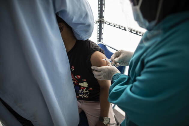 January 14, 2021, South Jakarta, Jakarta, Indonesia: Jakarta, Indonesia, 14 January 2021 : A participant hug bvy his friend as he affraid in reeceived the vaccine. Vaccination for health worker and front people in fighting covid19 at Jagakarsa Public Health Facility South Jakarta. Indonesia start vaccination covid19 begin 14 January 2021 with priority for health worker and front people in fighting covid19 South Jakarta Indonesia - ZUMAh128 20210114_zap_h128_009 Copyright: xDonalxHusnix