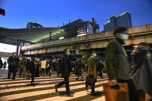 Day after Japan expands coronavirus emergency to 7 more prefectures People wearing face masks walk in Osaka s Umeda area on Jan. 14, 2021, a day after Japanese Prime Minister Yoshihide Suga declared a state of emergency in seven additional prefectures, including Osaka, amid the continued spread of the novel coronavirus. 