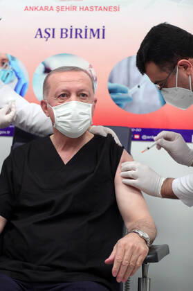 (210114) -- ANKARA, Jan. 14, 2021 () -- Turkish President Recep Tayyip Erdogan (L) receives a dose of COVID-19 vaccine at a hospital in Ankara, Turkey, on Jan. 14, 2021. Erdogan on Thursday received his first dose of vaccine as Turkey has started mass vaccination against COVID-19. () TURKEY-ANKARA-PRESIDENT-COVID-19 VACCINE Xinhua 
