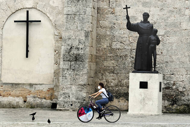 (210115) -- HAVANA, Jan. 15, 2021 -- A woman wearing a face mask rides a bike on a street in Havana, Cuba, Jan. 14, 2021. Local government in Havana announced new restrictive measures in response to the COVID-19 pandemic as 550 new cases were logged nationwide on Wednesday, setting a new daily record for the sixth day in a row. (Photo by Xinhua) CUBA-HAVANA-COVID-19-CASES JoaquinxHernandez 