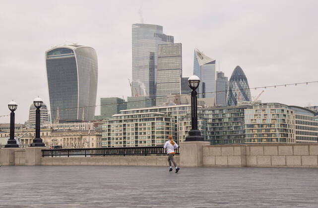 January 15, 2021, London, United Kingdom: A woman jogs next to the Thames with the City of London skyline in the background..England remains under lockdown as the government battles to keep the coronavirus pandemic under control. London United Kingdom - ZUMAs197 20210115_zab_s197_008 Copyright: xVukxValcicx
