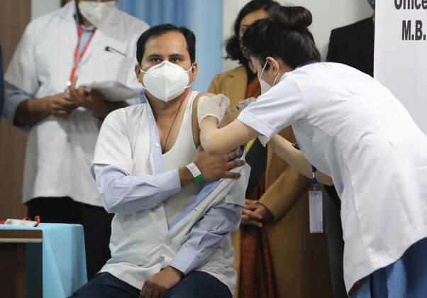January 16, 2021, New Delhi, India: A nurse seen vaccinating a front line medical worker at the All India Institute of Medical Science..The nationwide Covid-19 vaccination program began today in India. Frontline health workers are the first group of people to be vaccinated. New Delhi India - ZUMAs197 20210116_zaa_s197_096 Copyright: xNaveenxSharmax